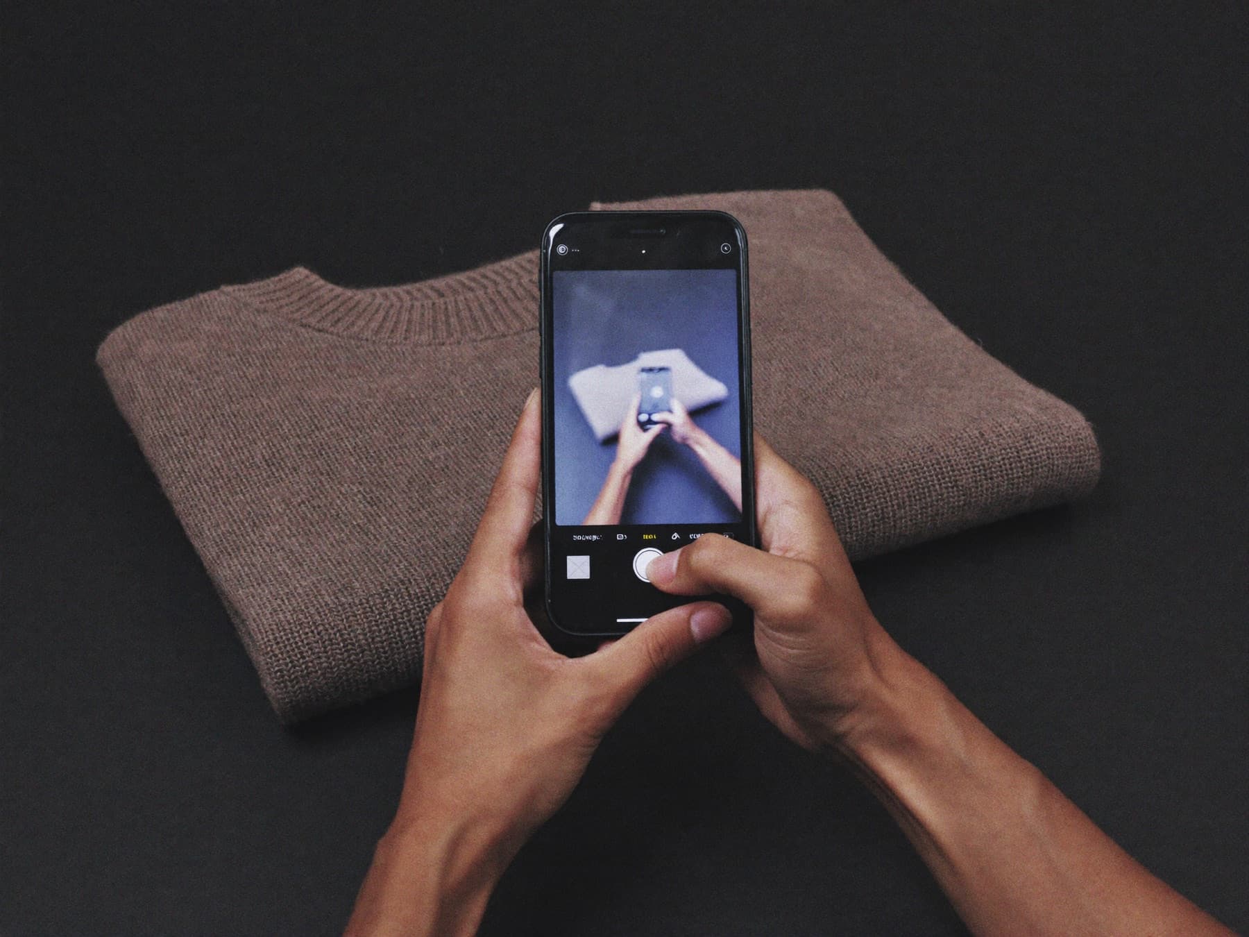 A garment being photographed with a phone